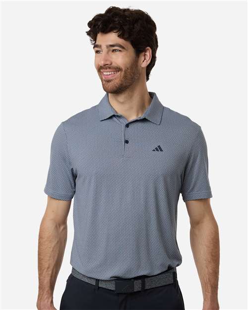 Man wearing a gray Adidas polo shirt on a white background