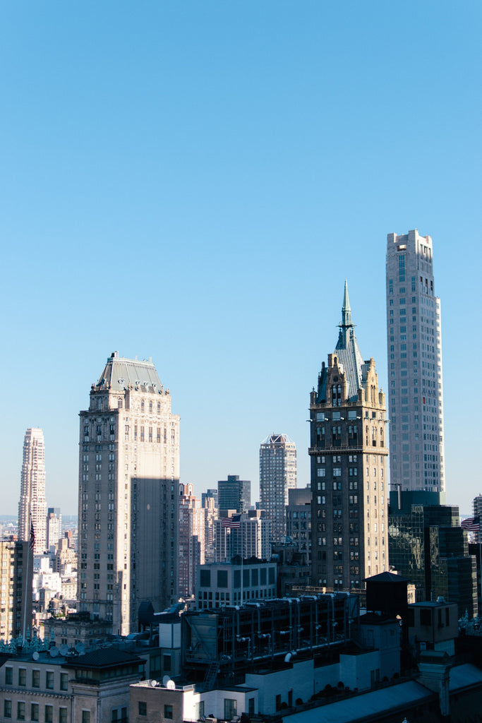 Downtown Chicago skyline under a clear blue sky—capturing the bold, urban energy behind Inkdnylon Custom Apparel’s embroidery, screen printing, and branded merch made to represent your city.
