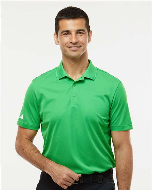Man wearing a green short-sleeve polo shirt with a collar and button placket