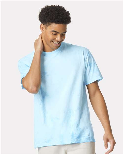 Person wearing a light blue colorblast short-sleeve t-shirt with a mottled pattern.