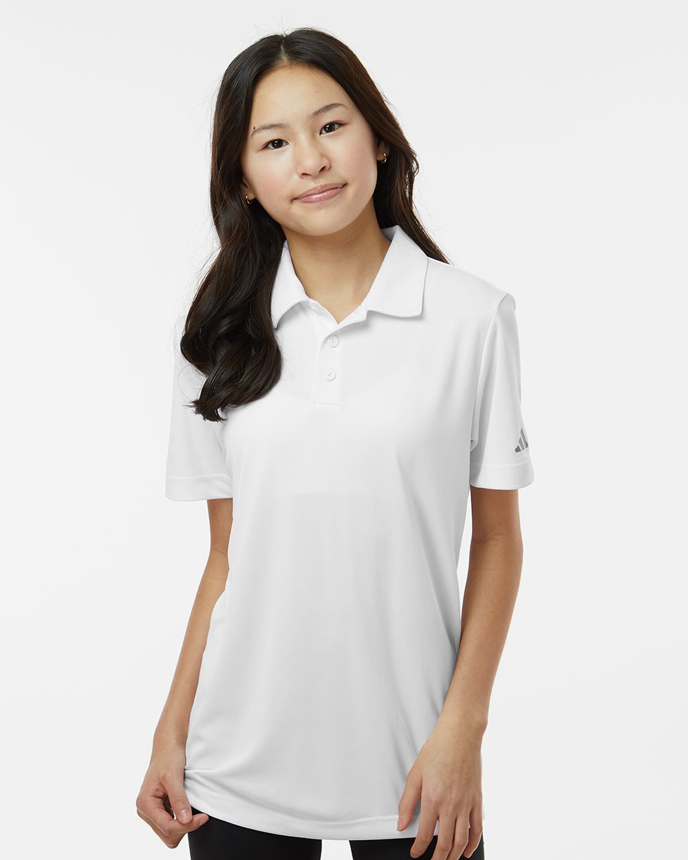 Person wearing a white polo shirt on a plain background