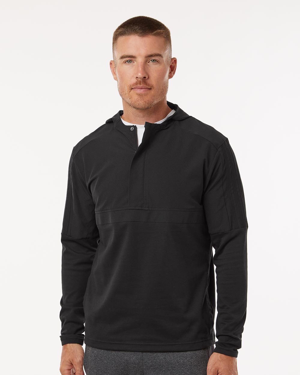 Black half-zip hooded anorak with long raglan sleeves, worn over a white crew neck tee.