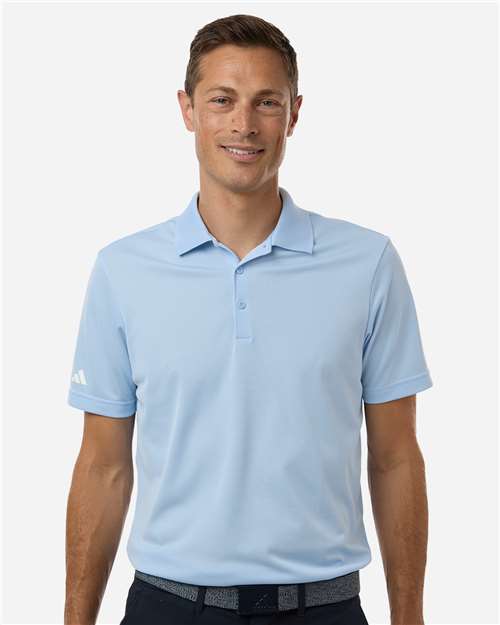 Man wearing a light blue short-sleeve polo shirt with a collar and button placket