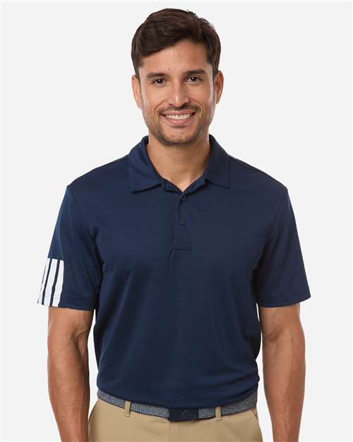 Man wearing a navy blue polo shirt with white stripes on sleeves against a white background