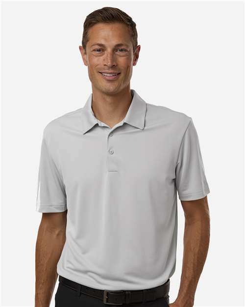 Man wearing a light gray polo shirt on a white background