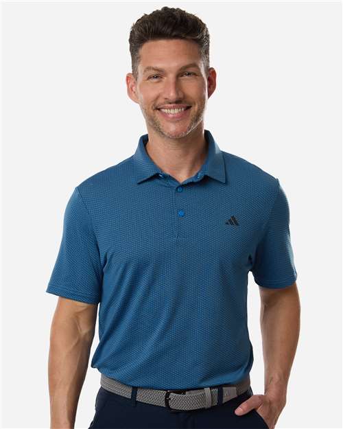 Man wearing a blue Adidas polo shirt on a white background