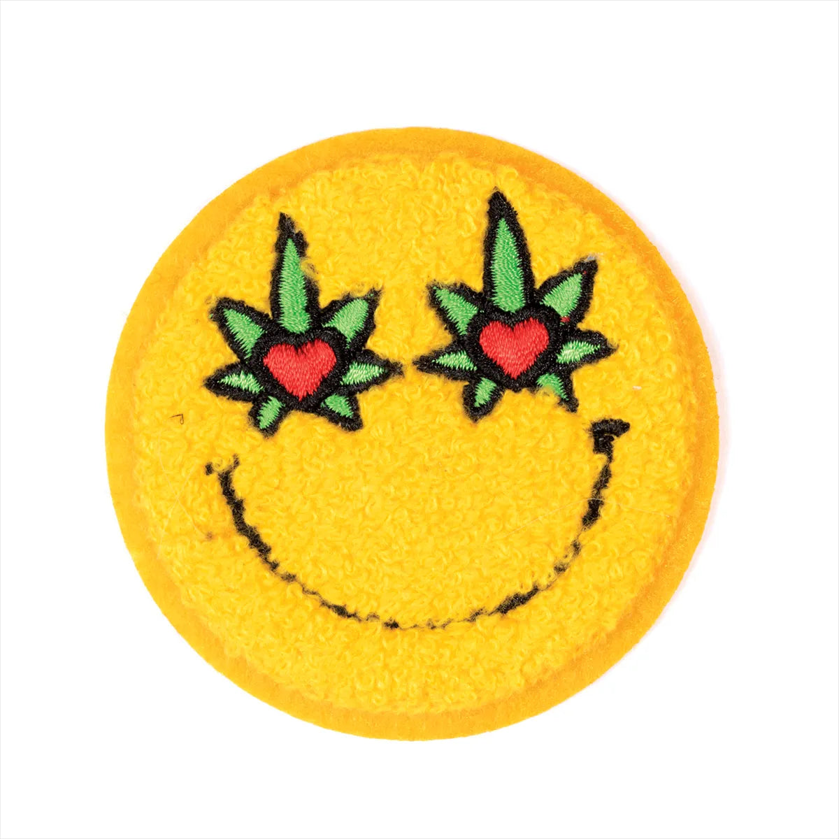 Smiley face patch with heart and leaf designs on a white background