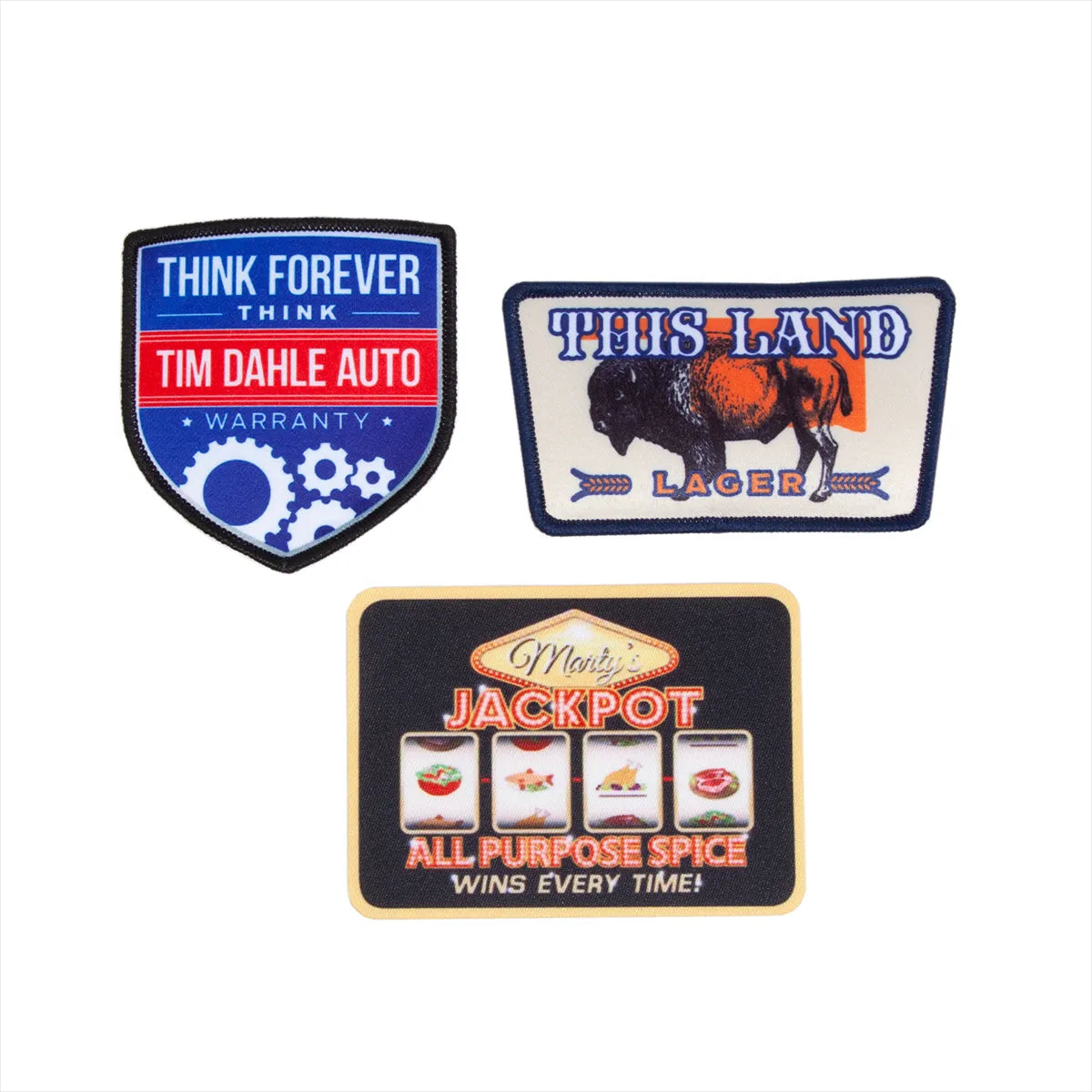 Three vintage-style patches with different designs on a white background