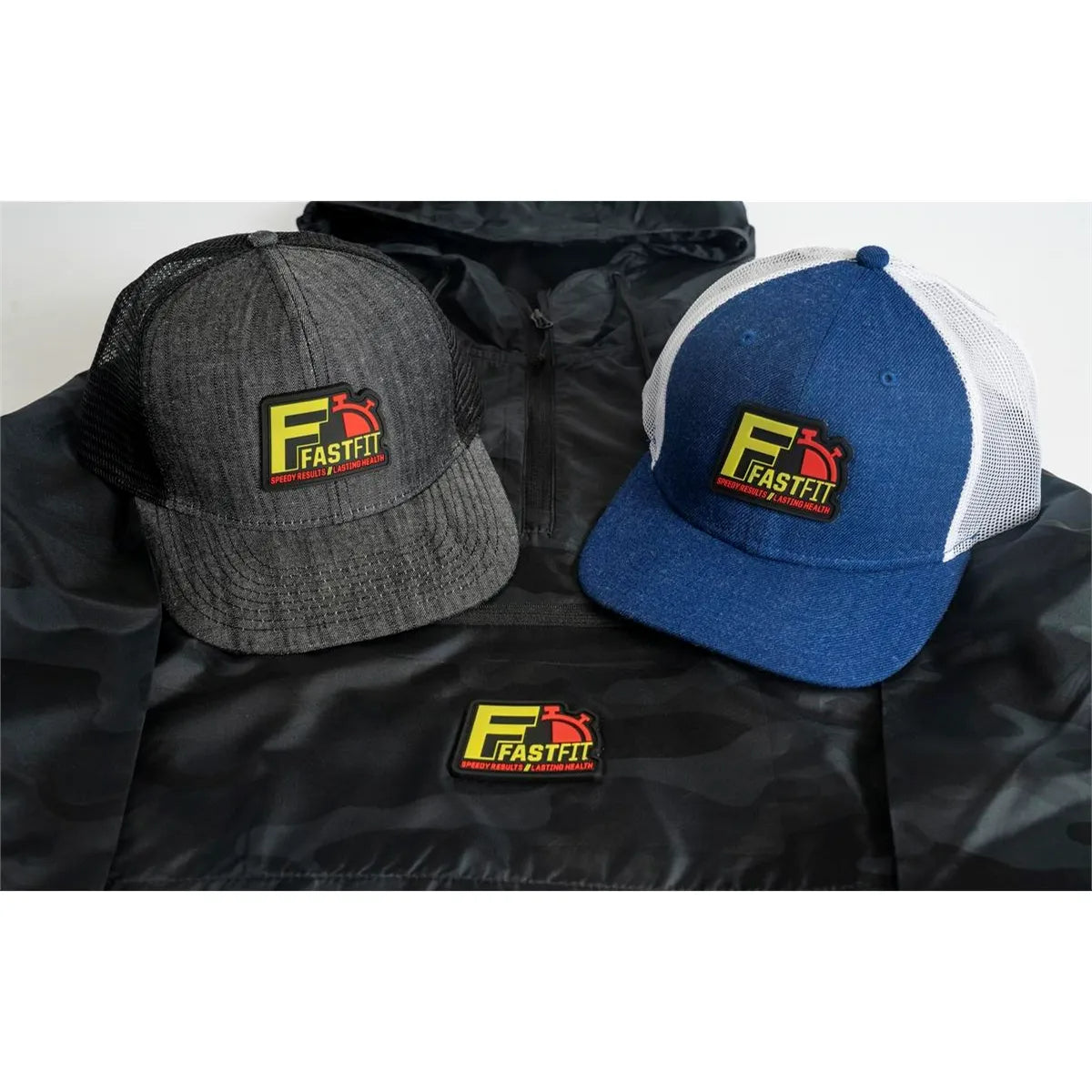Two hats with FastFit logo on a black jacket
